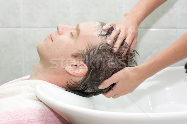 Blonde in a salon getting washed her hair Stock photo © podsolnukh