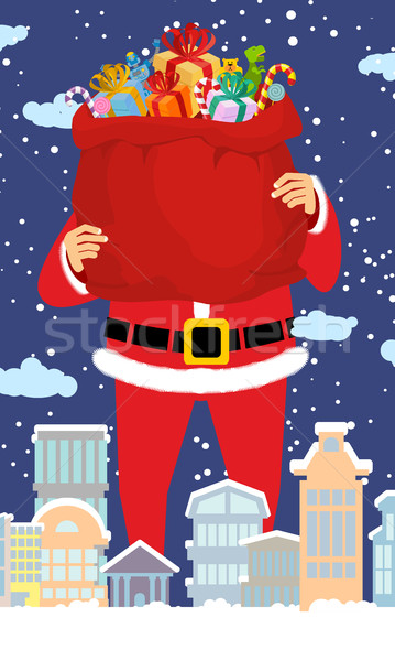 Santa Claus and bag of gifts in city. Christmas in town. Snow an Stock photo © popaukropa