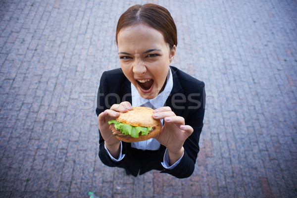 Hunger Bild hungrig Geschäftsfrau Sandwich schauen Stock foto © pressmaster