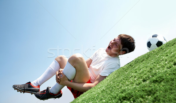 Douleur jambe image footballeur couché Photo stock © pressmaster