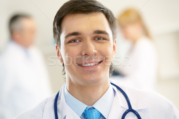 Practicante retrato alegre médico estetoscopio mirando Foto stock © pressmaster