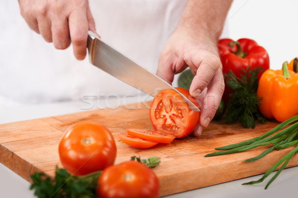 Stock photo: Cutting tomatoes