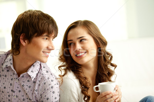 Flirty wygląd szczęśliwy lovers patrząc inny Zdjęcia stock © pressmaster