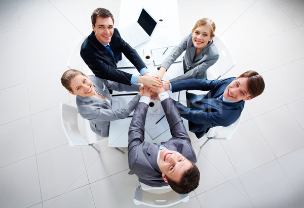 Heureux partenaires au-dessus vue gens d'affaires mains Photo stock © pressmaster