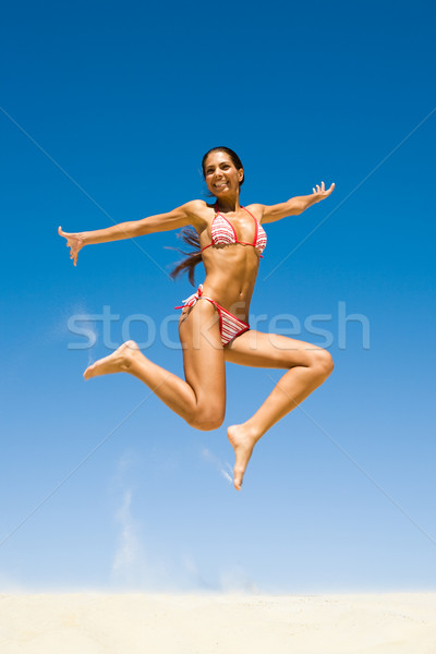 Levegő fotó fiatal boldog lány homokos tengerpart fényes Stock fotó © pressmaster