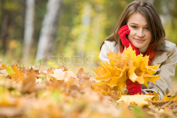 Girl upon leafed ground Stock photo © pressmaster