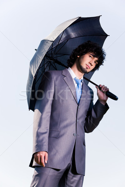 [[stock_photo]]: Homme · parapluie · portrait · sérieux · affaires · permanent