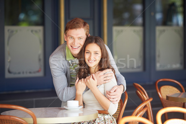 Vonzalom boldog fickó átkarol barátnő kávézó Stock fotó © pressmaster