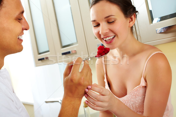 Tentation jeune femme manger framboise cuillère femme Photo stock © pressmaster