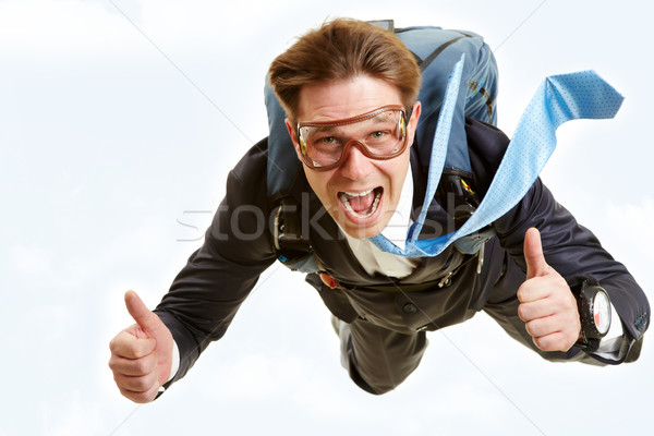 Imagem feliz homem voador pára-quedas Foto stock © pressmaster