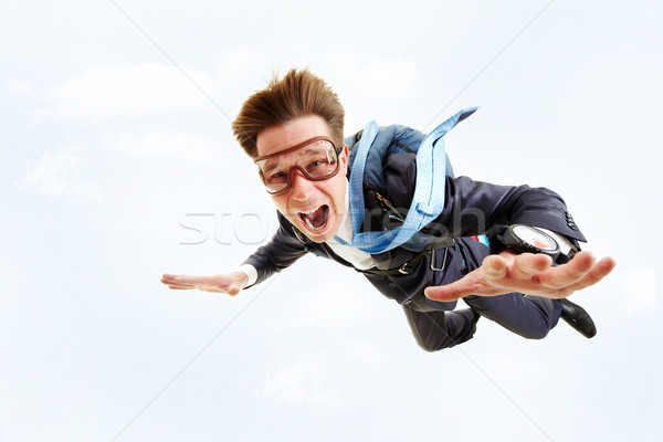 Lotu obraz młodych biznesmen pływające spadochron Zdjęcia stock © pressmaster