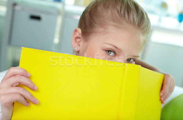 Peeking out of book Stock photo © pressmaster