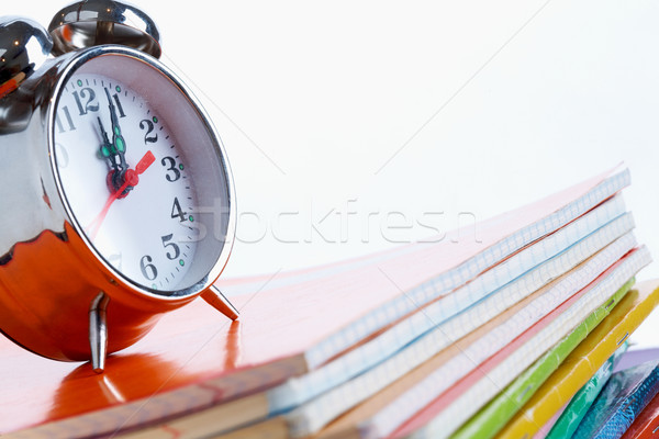 Alarm clock on copybooks Stock photo © pressmaster