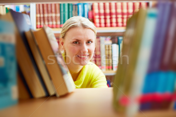 Peeking out of books Stock photo © pressmaster