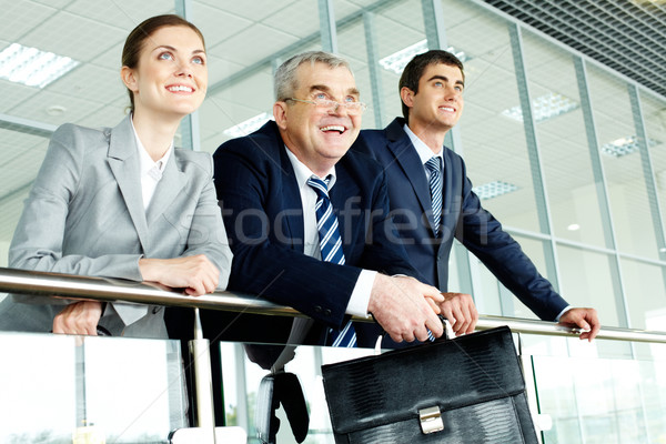 Feliz socios tres gente de negocios oficina pie Foto stock © pressmaster