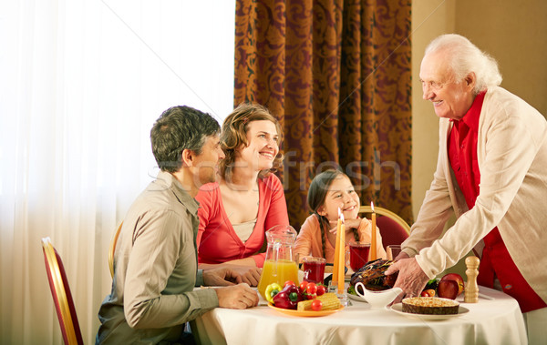 Gathered at dinner table Stock photo © pressmaster