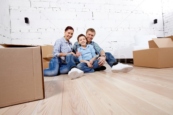 új ház fiatal család három ül padló Stock fotó © pressmaster
