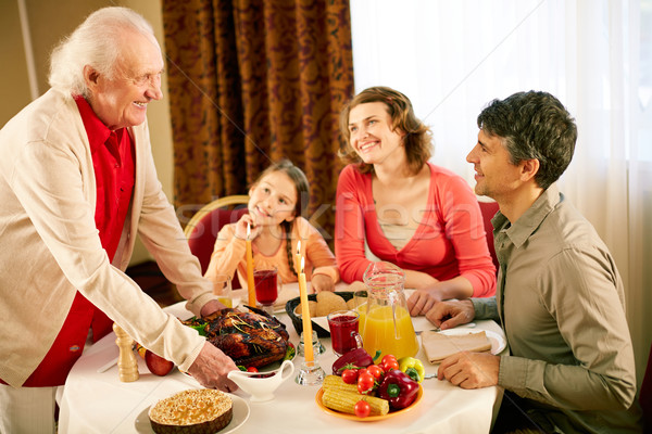 Gathered at dinner table Stock photo © pressmaster