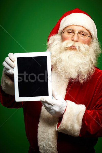 聖誕老人 觸摸板 肖像 聖誕老人 看 相機 商業照片 © pressmaster