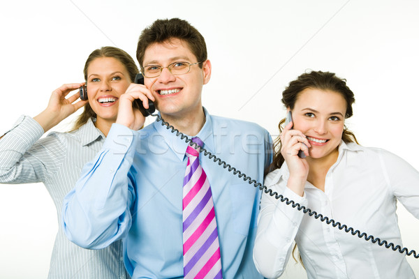 Tanácsadók csoport mosolyog beszél telefonok fehér férfi Stock fotó © pressmaster