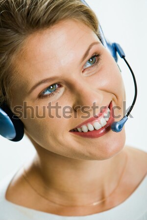 Bella receptionist giovani imprenditrice auricolare guardando Foto d'archivio © pressmaster