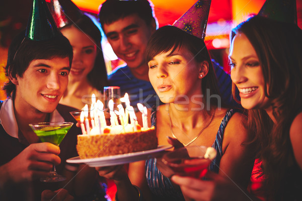 Blowing on candles in the dark Stock photo © pressmaster