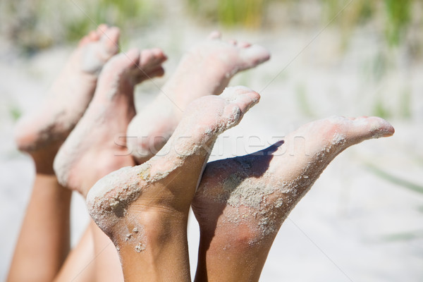 Humanos cubierto arena senalando verano Foto stock © pressmaster