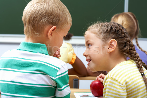 Beszélget portré iskolás gyerekek ül osztályterem lecke Stock fotó © pressmaster