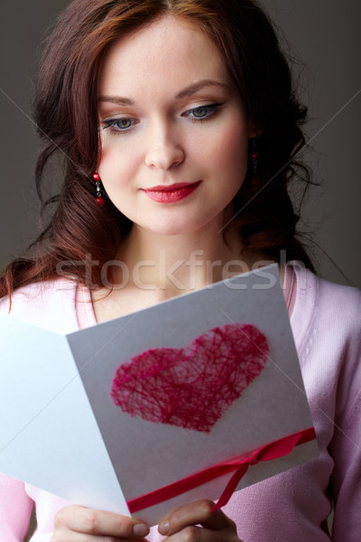 Girl reading card Stock photo © pressmaster