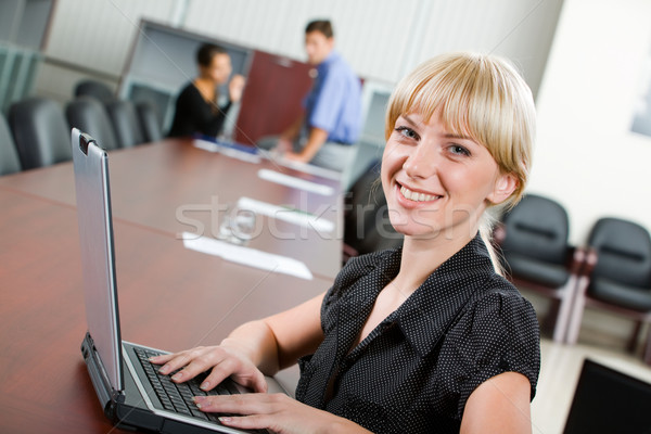 Souriant spécialiste regarder caméra boardroom affaires [[stock_photo]] © pressmaster