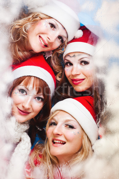 Stock photo: beautiful women wearing a santa hat
