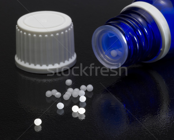 Stock photo: small bottle and globules