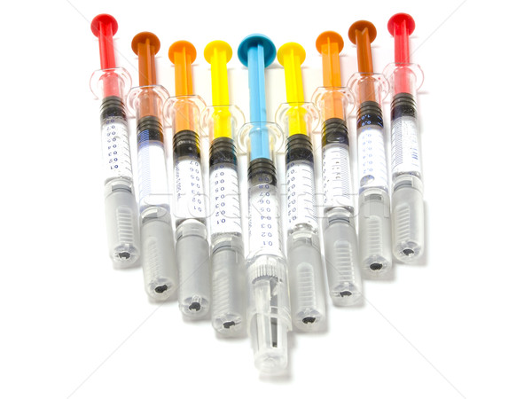Syringes with colored pistons Stock photo © Pruser