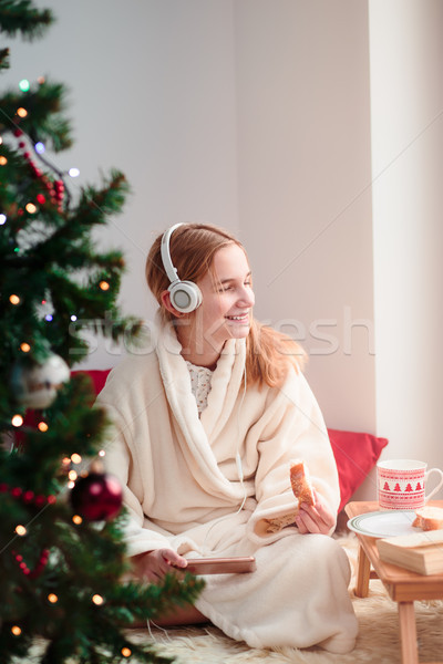 Stock photo: Girl listening to Christmas carols
