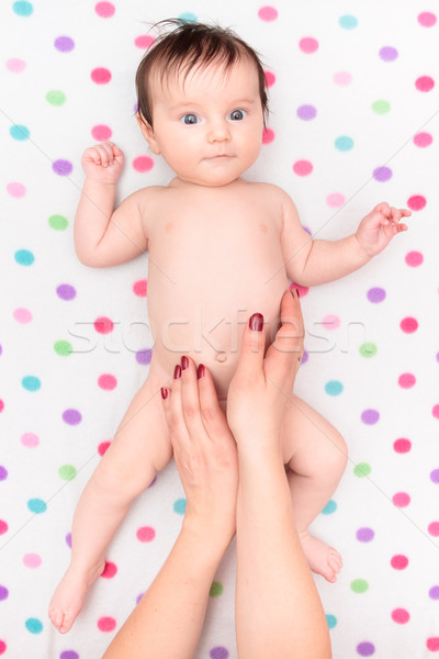 Little baby girl lying on blanket with colourful polka dots Stock photo © przemekklos