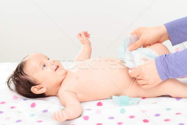 Mom changing diaper her little baby girl Stock photo © przemekklos