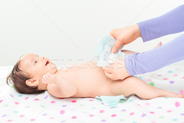 Mom changing diaper her little baby girl Stock photo © przemekklos