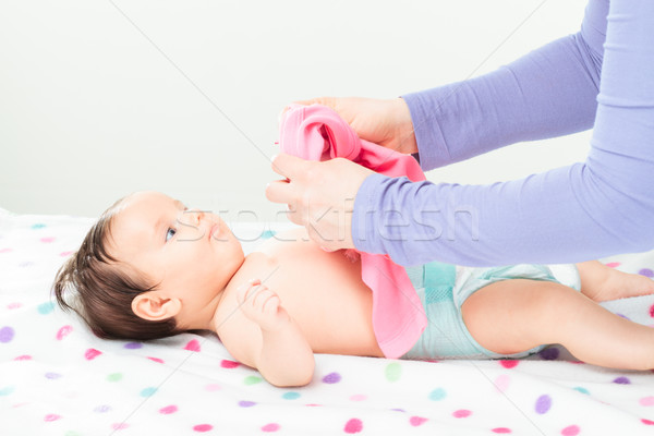 Mom dressing her little baby Stock photo © przemekklos