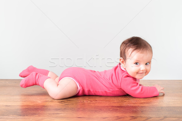 Smiling little baby girl playing on the floor Stock photo © przemekklos