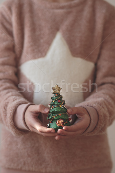 Girl holding Christmas tree figurine Stock photo © przemekklos