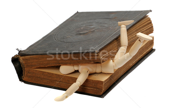 wooden doll captured by old book Stock photo © pterwort