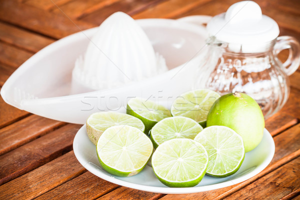 Stock photo: Fresh lime with glass jar and hand squash tool