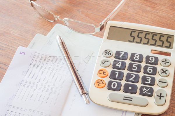 Calculator, pen and eyeglasses on bank account passbook Stock photo © punsayaporn