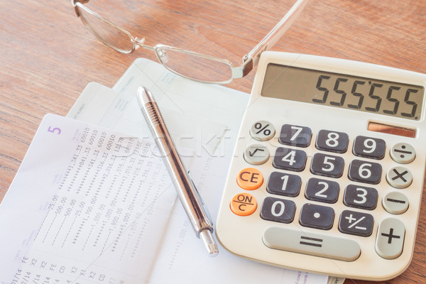 Stock photo: Calculator, pen and eyeglasses on bank account passbook