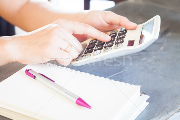 Hands holding and press calculator Stock photo © punsayaporn