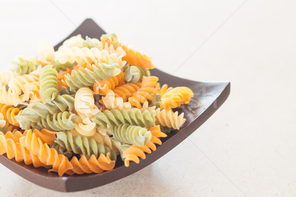 Raw fusilli pasta on wooden tray Stock photo © punsayaporn