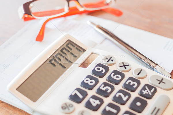 Calculator, pen and on bank account passbook Stock photo © punsayaporn