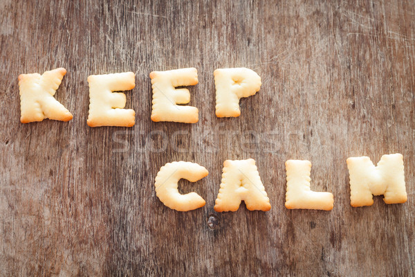 Keep calm alphabet biscuit on wooden table Stock photo © punsayaporn