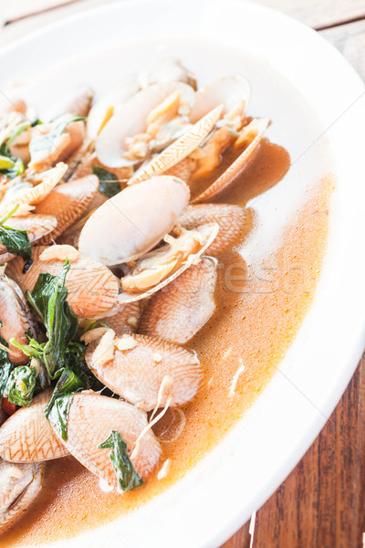 Stir fried clams with roasted chili paste on white plate Stock photo © punsayaporn