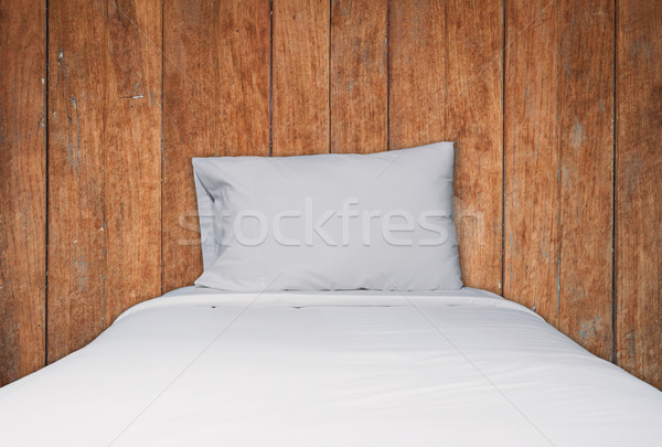 Close up white bedding and pillow on wooden texture background Stock photo © punsayaporn